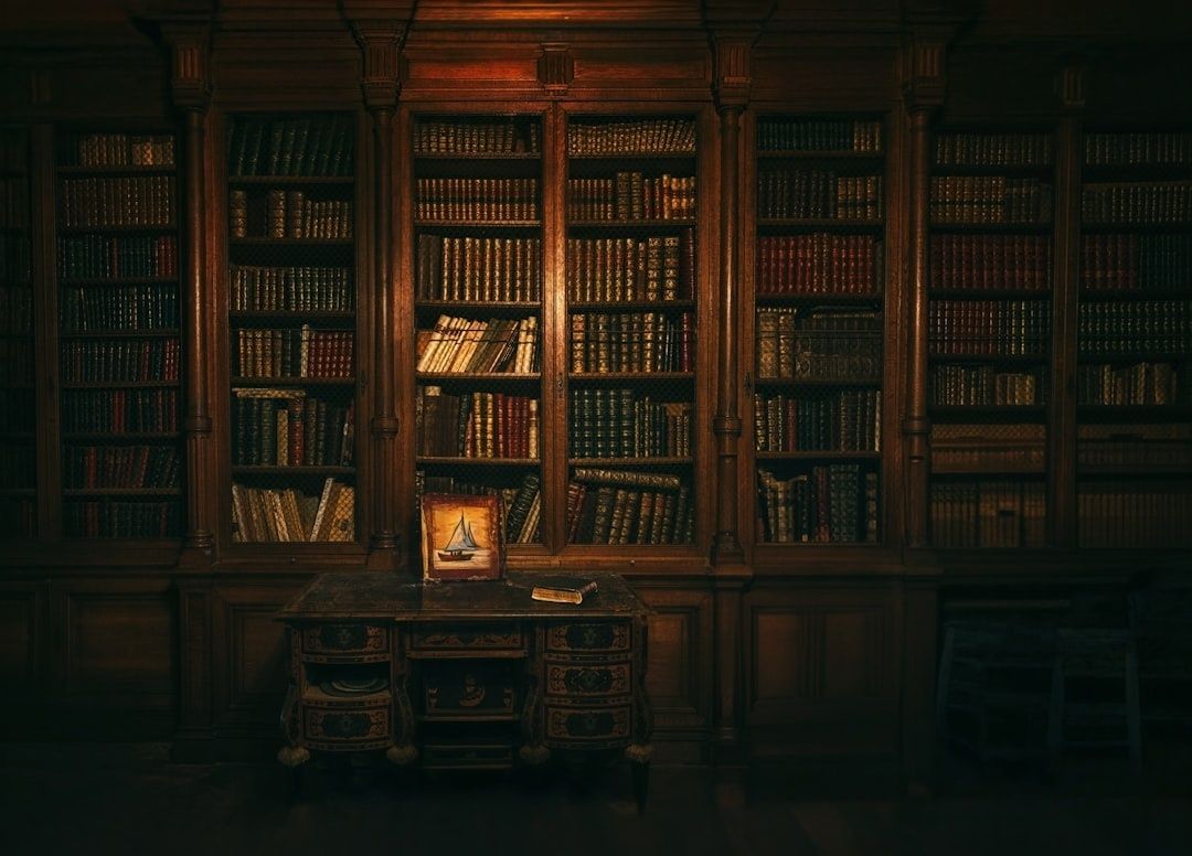 Candlelit library with dark wood shelves and an ornate writing desk