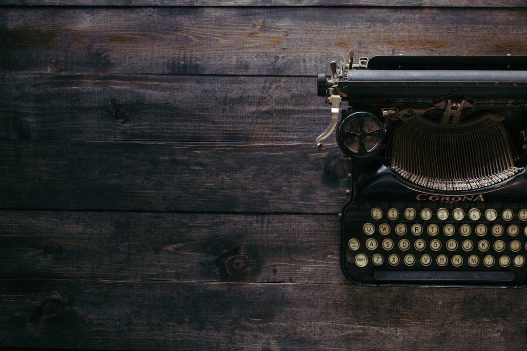 Vintage Corona typewriter on a dark wooden surface